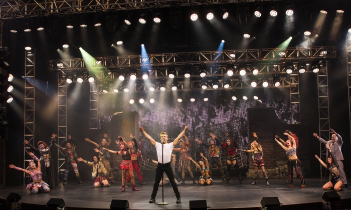 The We Will Rock You Show on Anthem of the Seas with a performer in the foreground.