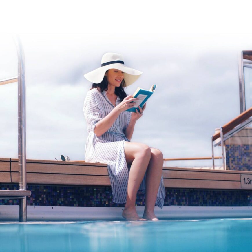 A woman reading a book onboard a Cunard ship